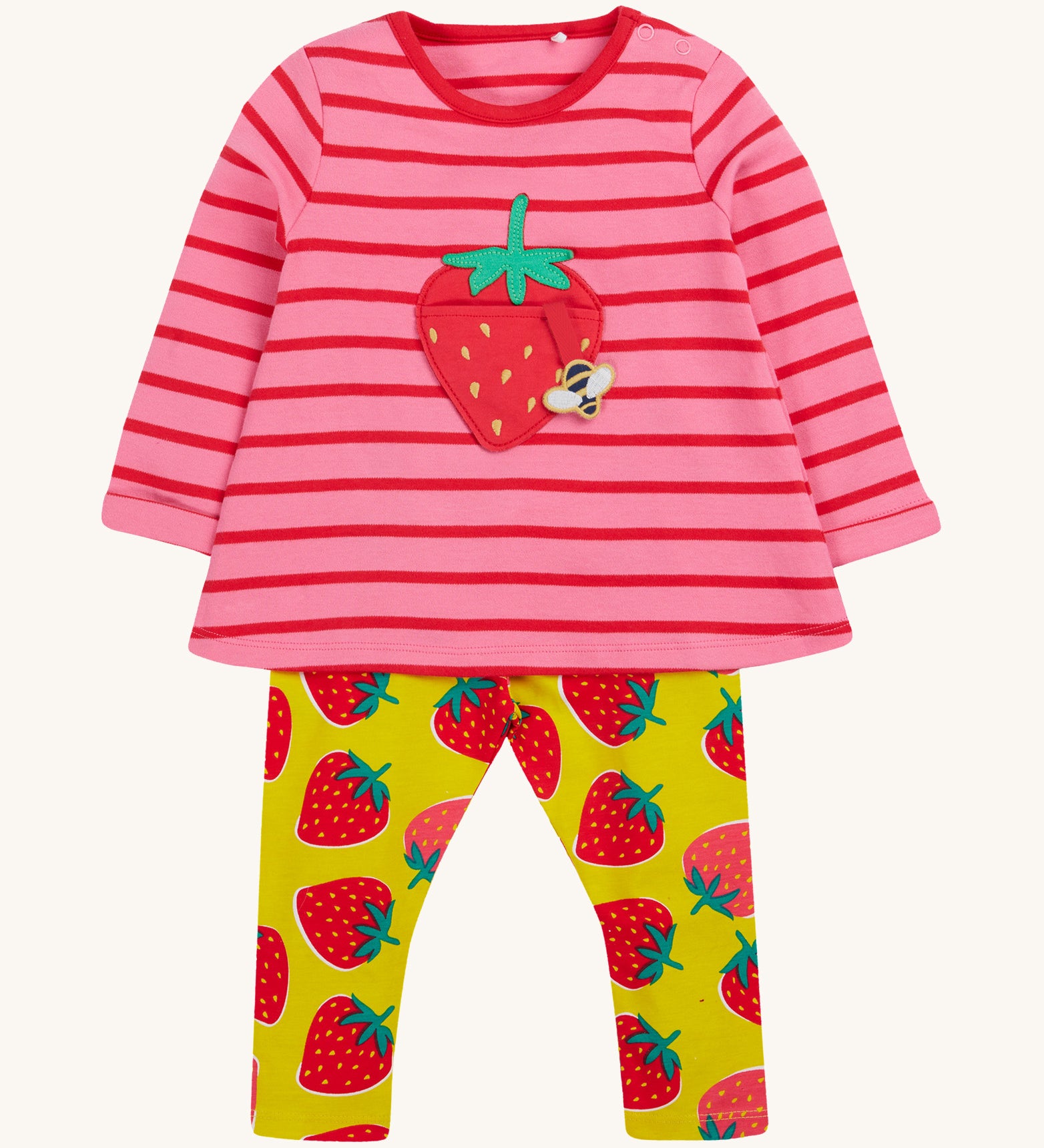 Frugi pink stripe yellow strawberry outfit on a cream background.