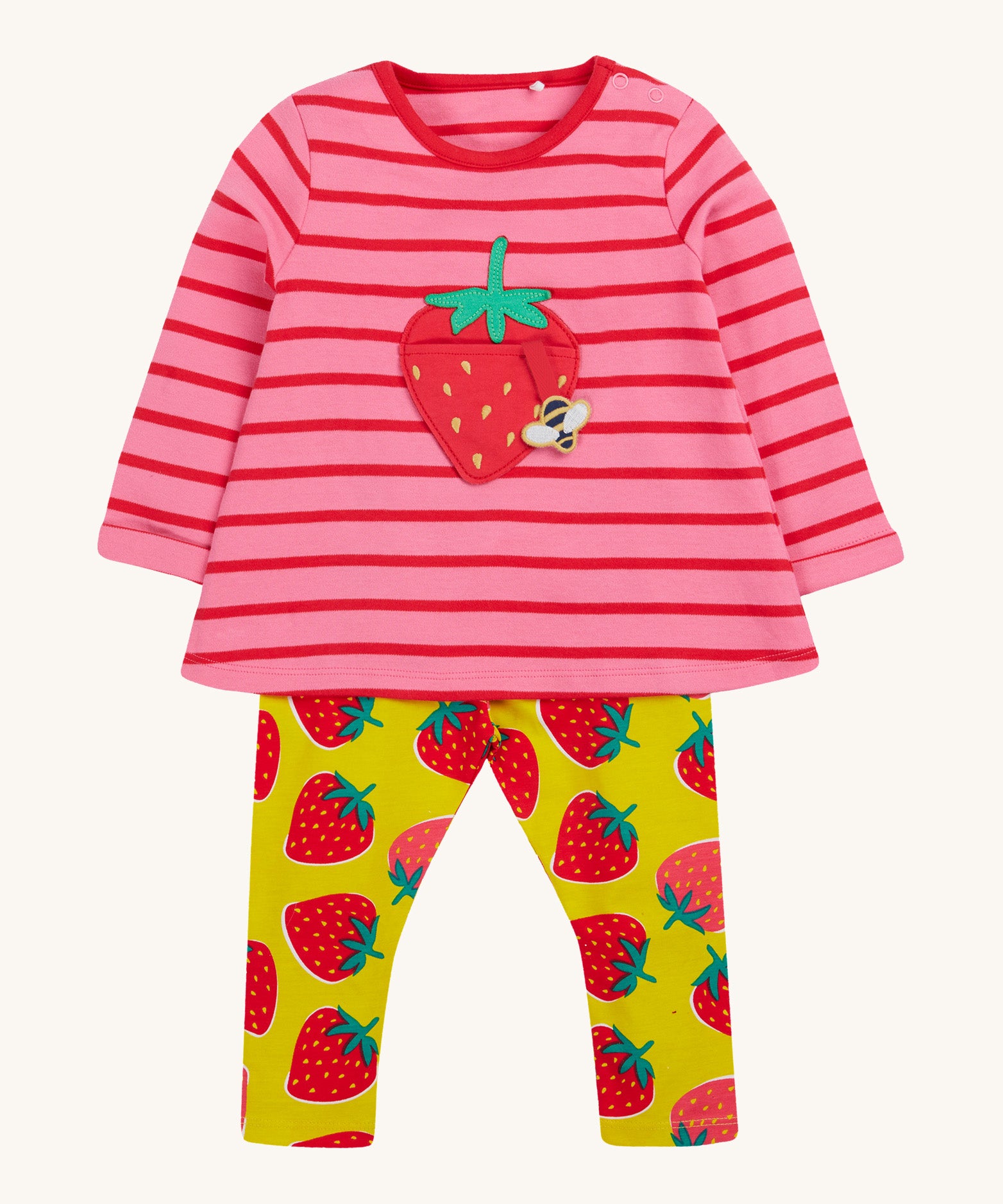 Frugi pink stripe yellow strawberry outfit on a cream background.