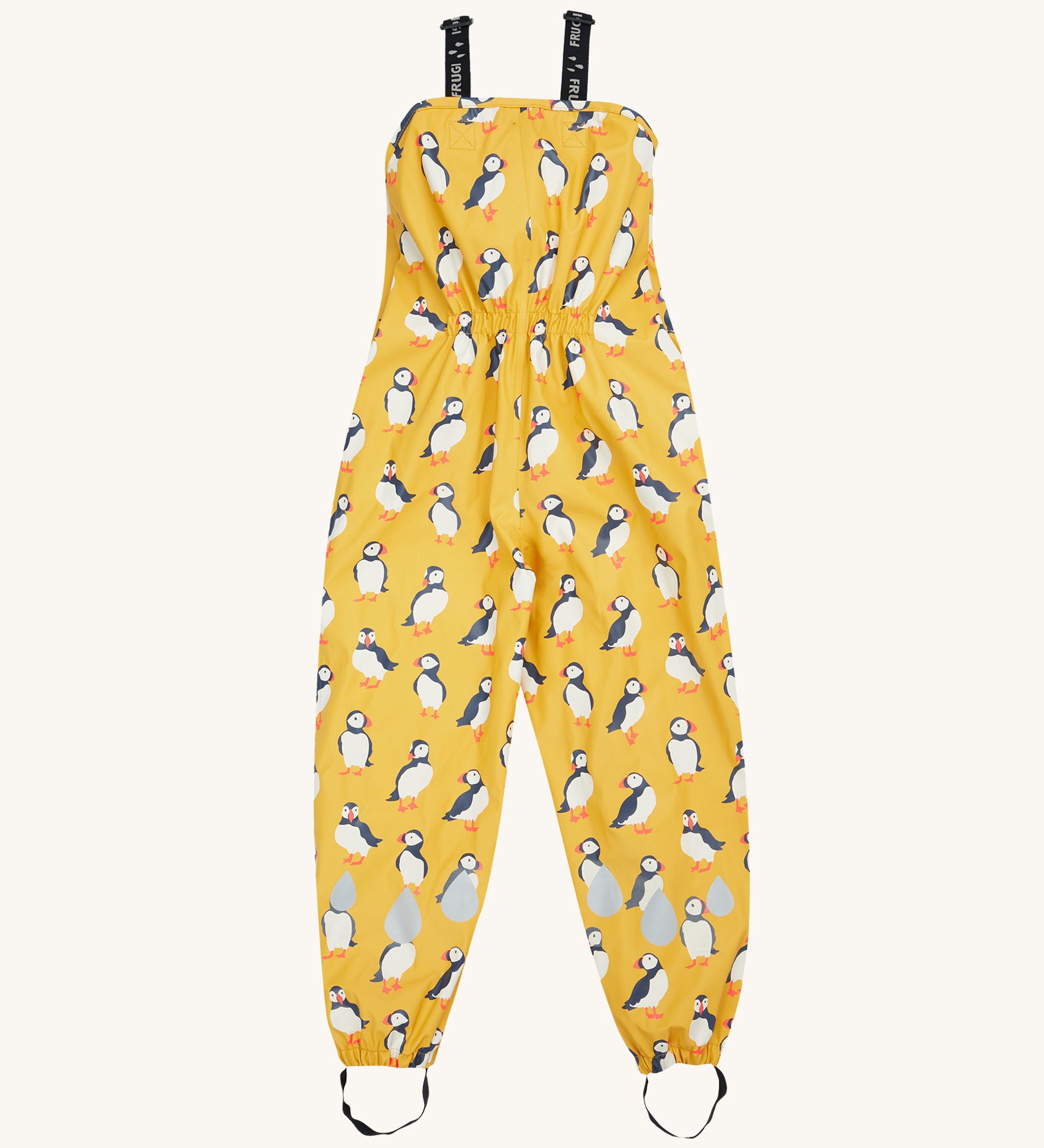 Frugi yellow puddle buster trousers puffin design on a cream background.