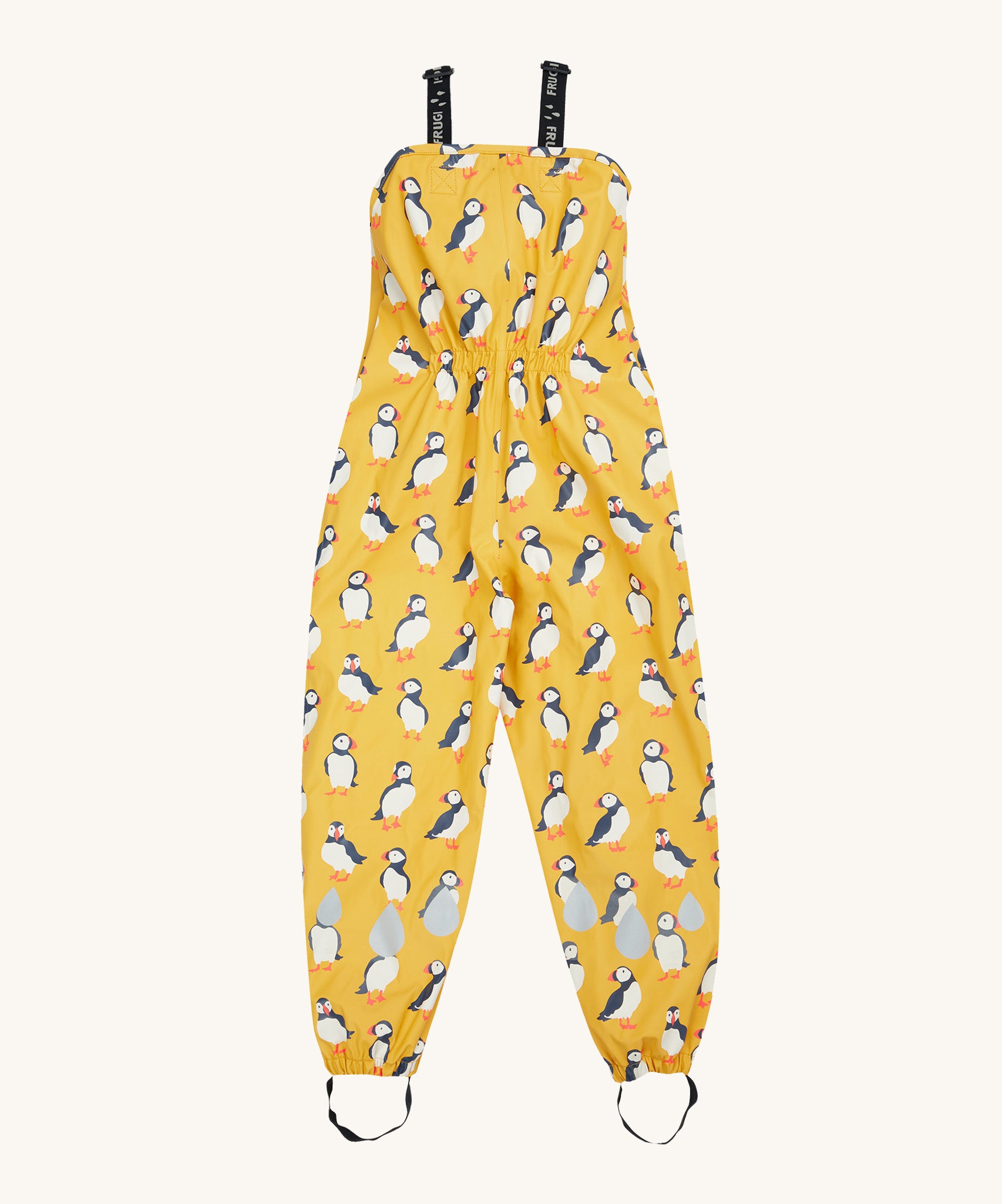 Frugi yellow puddle buster trousers puffin design on a cream background.