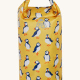 Frugi yellow dry bag puffin design on a cream background.