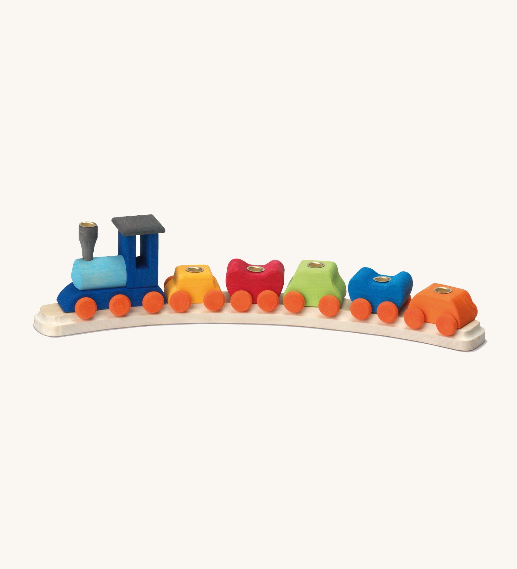 Glückskäfer birthday train is an heirloom piece consisting of 6 train sections in colourful wood, on a wooden train track. Each section has a hole to place a candle. The image is on a cream background