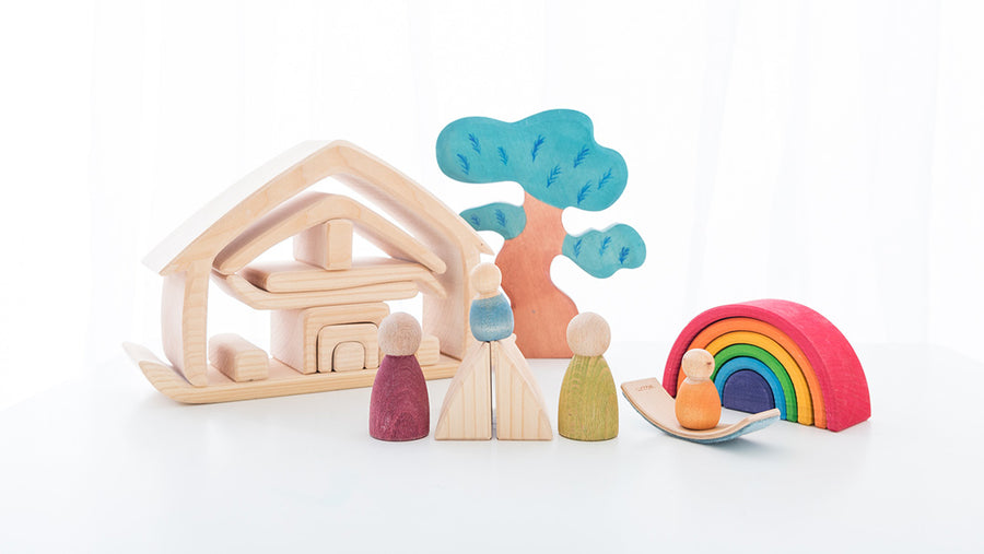 Gluckskafer wooden house with some Grimm's peg dolls, a Bumbu tree, and a mini rainbow