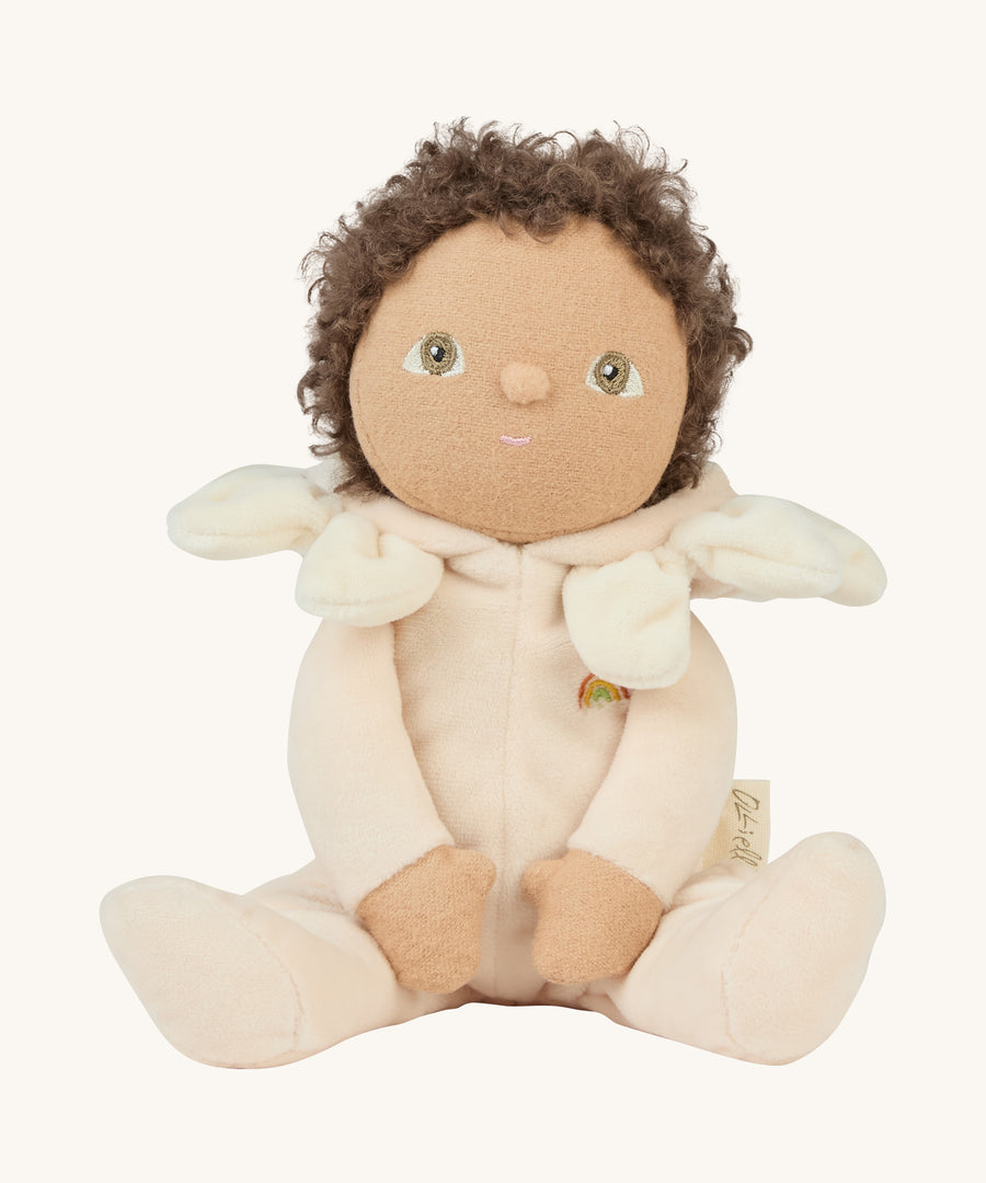 The light cream dinky dinkum doll with the hood down on a cream background.