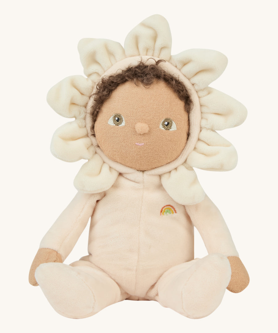 A light cream dinky dinkum doll sitting on a cream background