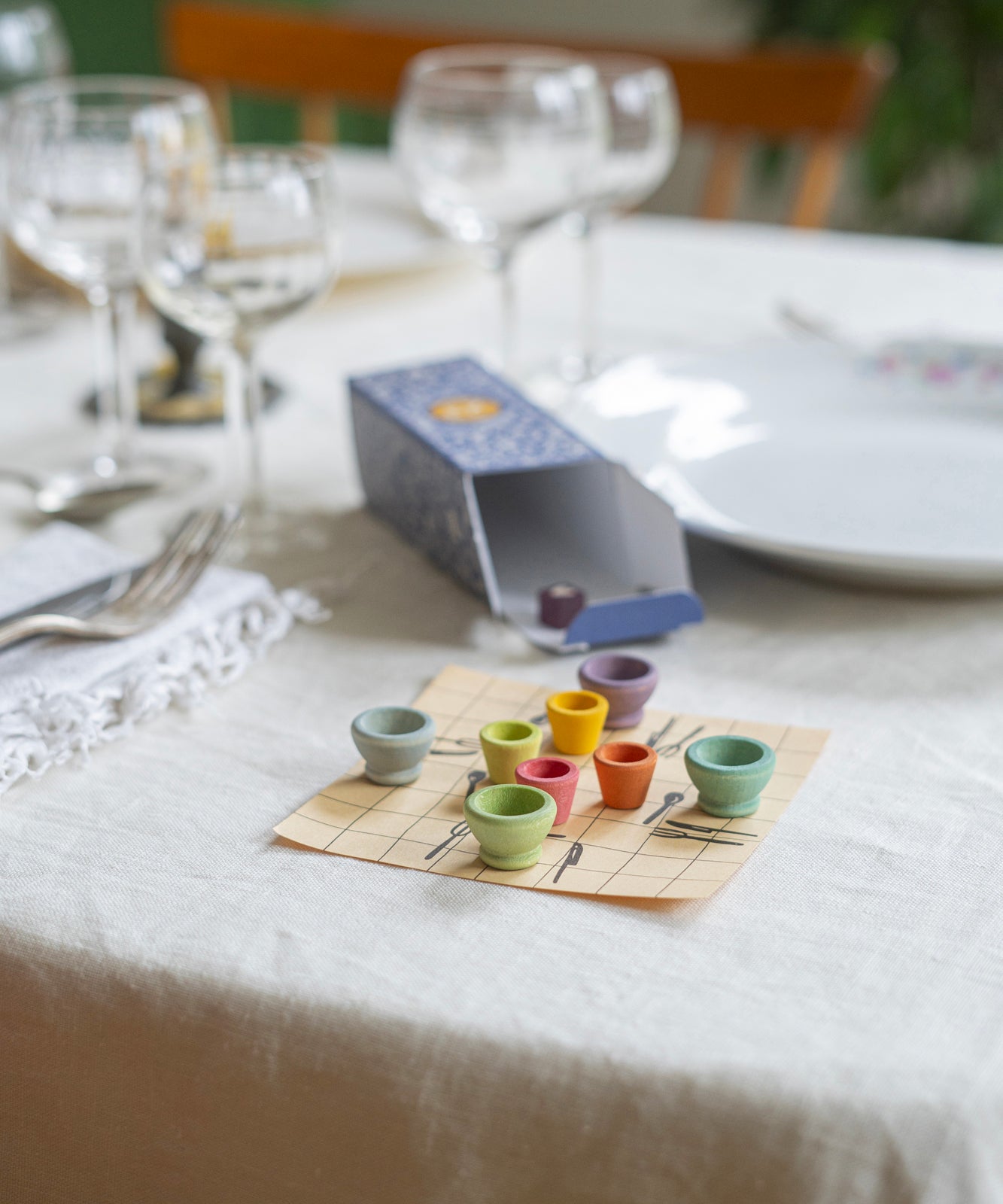 A closer view of the small wooden pots from the Grapat Advent Calendar 2024, set on a table