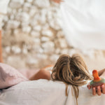 A child holding the Grapat wooden mellow orange bird 