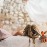 A child holding the Grapat wooden mellow orange bird 