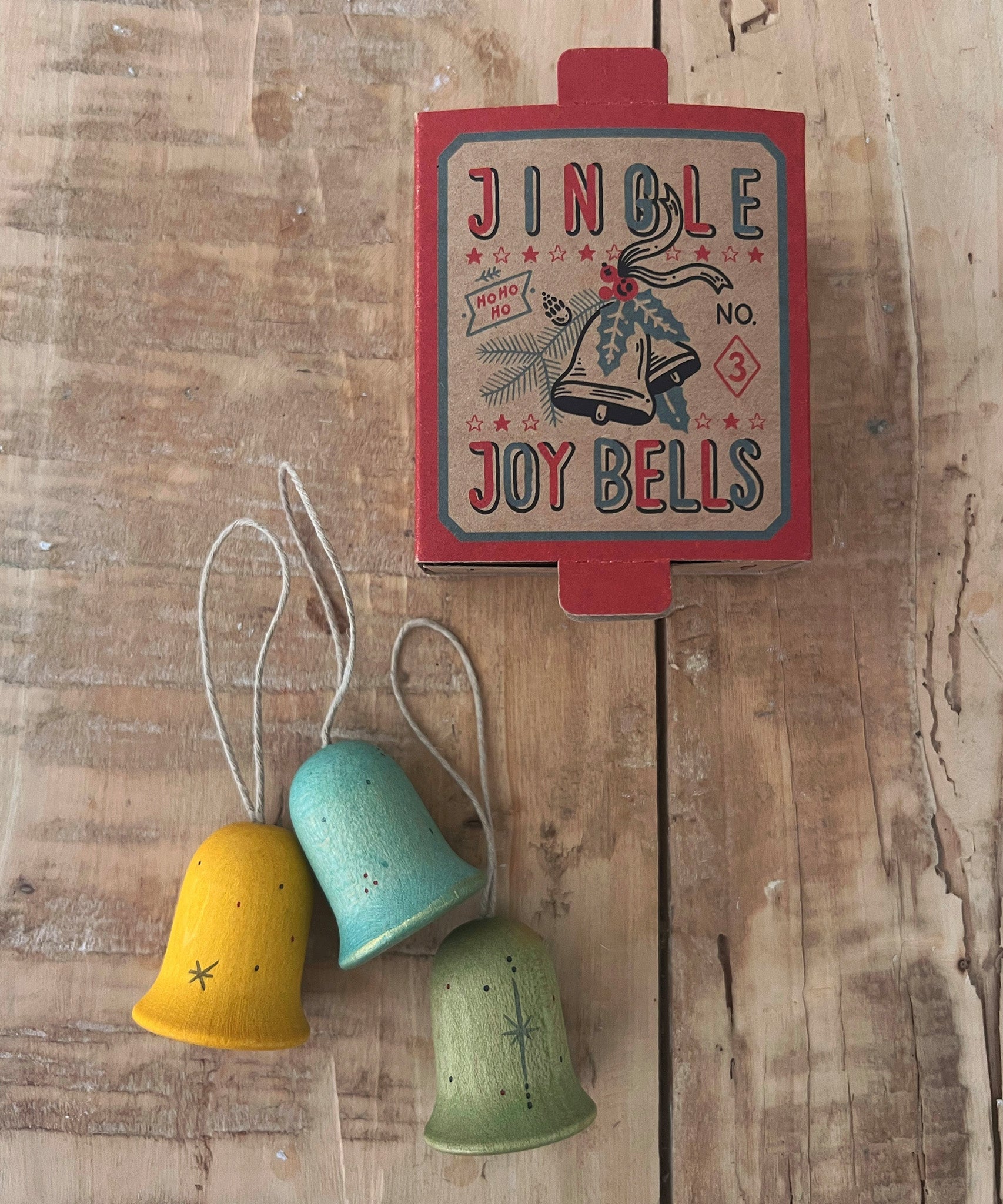 Grapat Wooden Christmas Ornaments - Jingle Joy Bells. Beautifully hand made, and hand painted Christmas ornaments, with an heirloom quality to be used year after year. Snow Buddy consists of 3 bell shaped ornaments, painted in yellow, blue and green with hand painted stars.