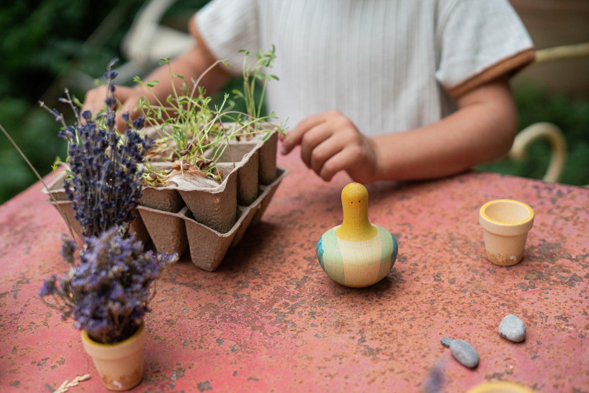 A Grapat wooden yellow flowing bird outside on a table