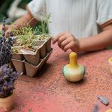 A Grapat wooden yellow flowing bird outside on a table