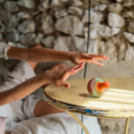 2 children playing with the Grapat wooden mellow orange bird on a table