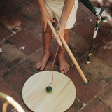 A child holding the  Grapat wooden pendulum set