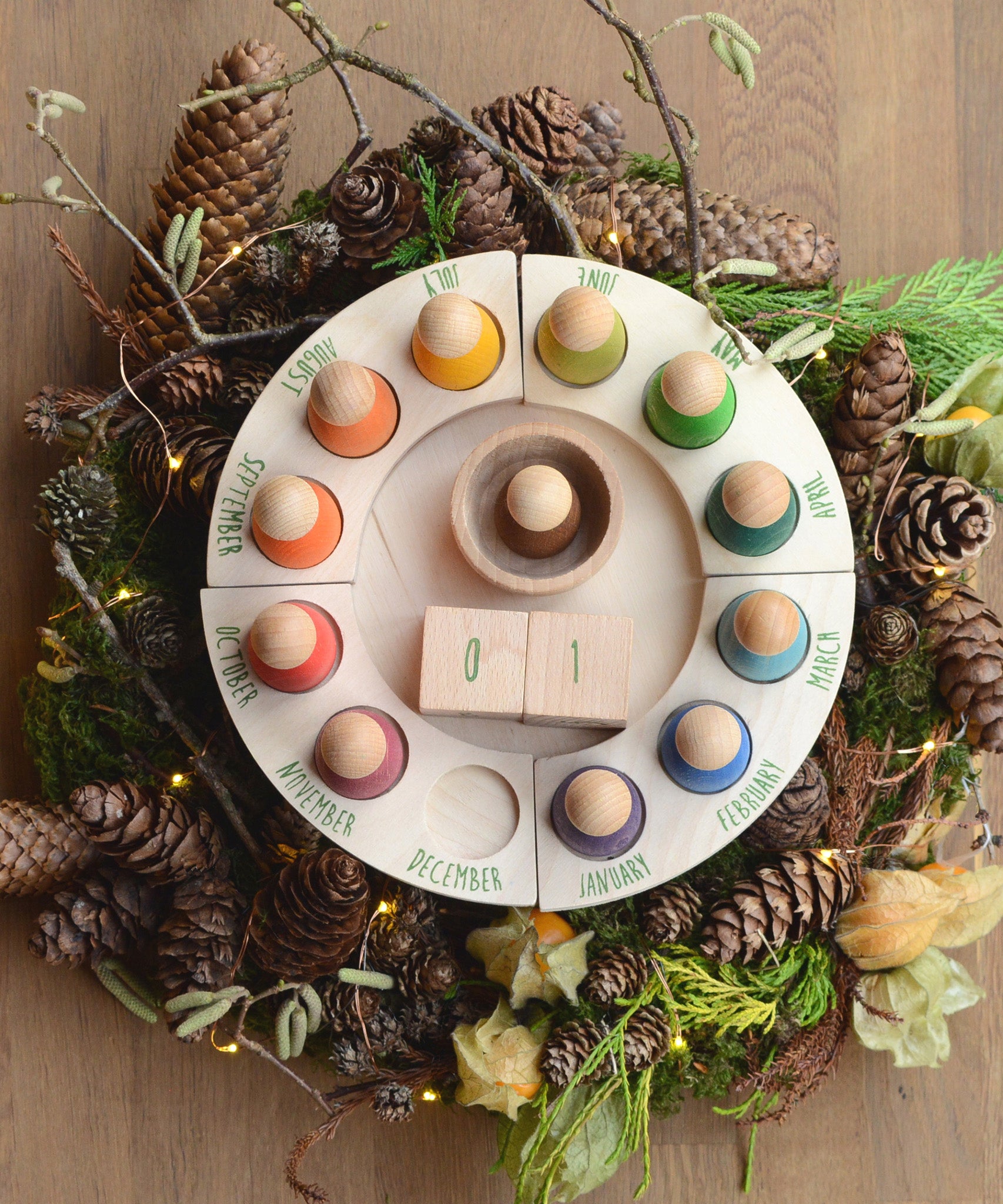 Grapat Perpetual Calendar, a beautiful winter display with a pine-cone wreath surrounding the outside of the calendar.