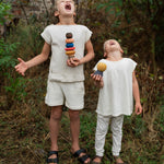 2 children holding the Grapat serendipity stacking set outside