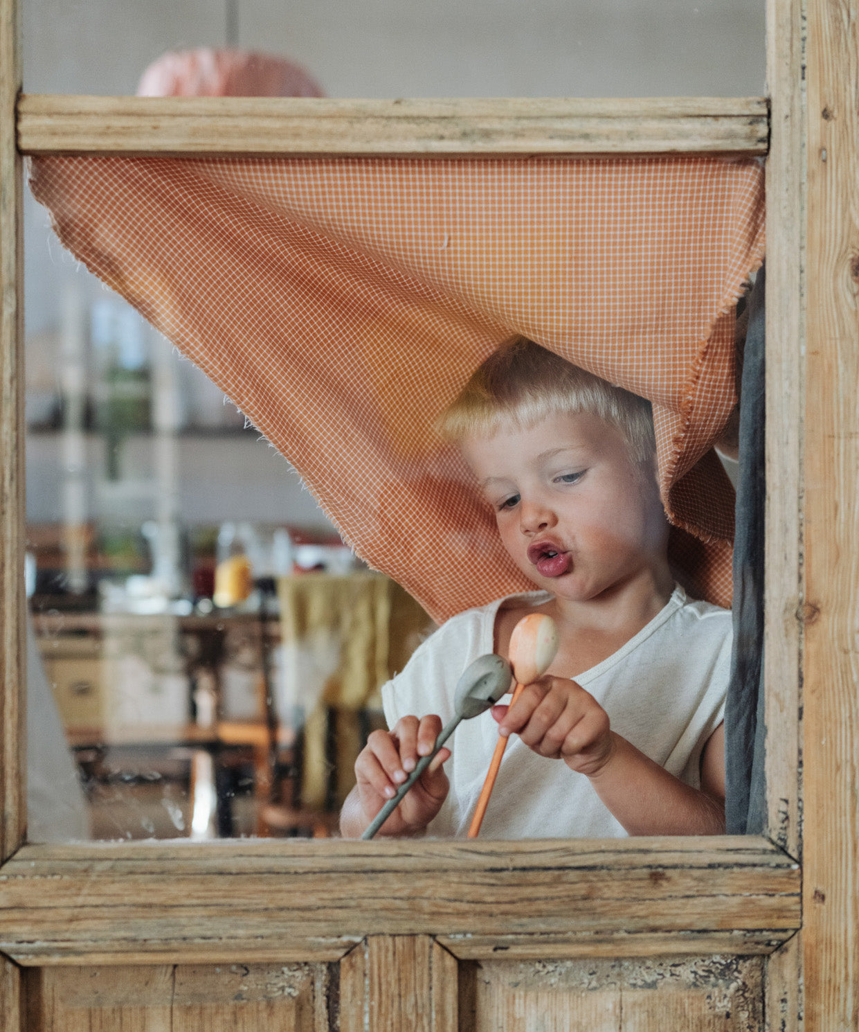 Grapat wooden twin soul puppets played with behind a window frame 