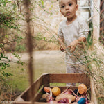 A child playing with the Grapat serendipity stacking set stored in a basket