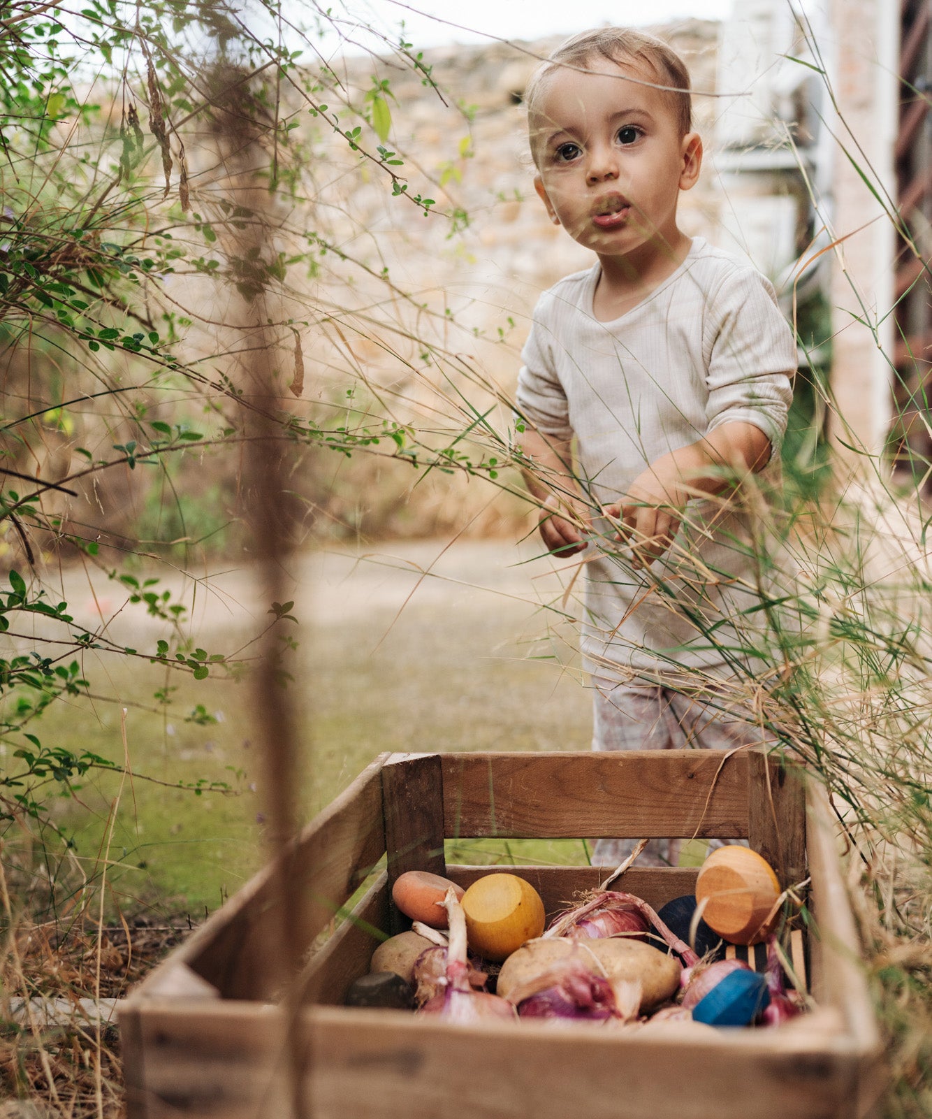 A child playing with the Grapat serendipity stacking set stored in a basket