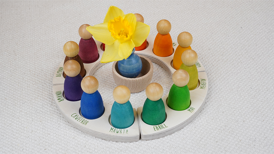 A Grapat calendar with rainbow coloured Nins, in a Spring seasonal theme