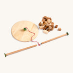 Grapat wooden pendulum set next to wooden blocks on a cream background.