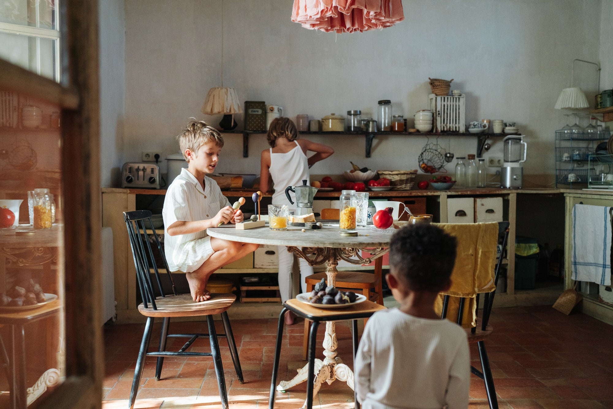 A child playing with the Grapat wooden twin soul puppets by a table