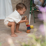 A child playing with the Grapat serendipity stacking set outside on the floor