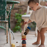 A child playing with the Grapat serendipity stacking set outside on the floor