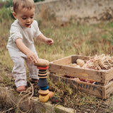 A child playing with the Grapat serendipity stacking set outside on grass