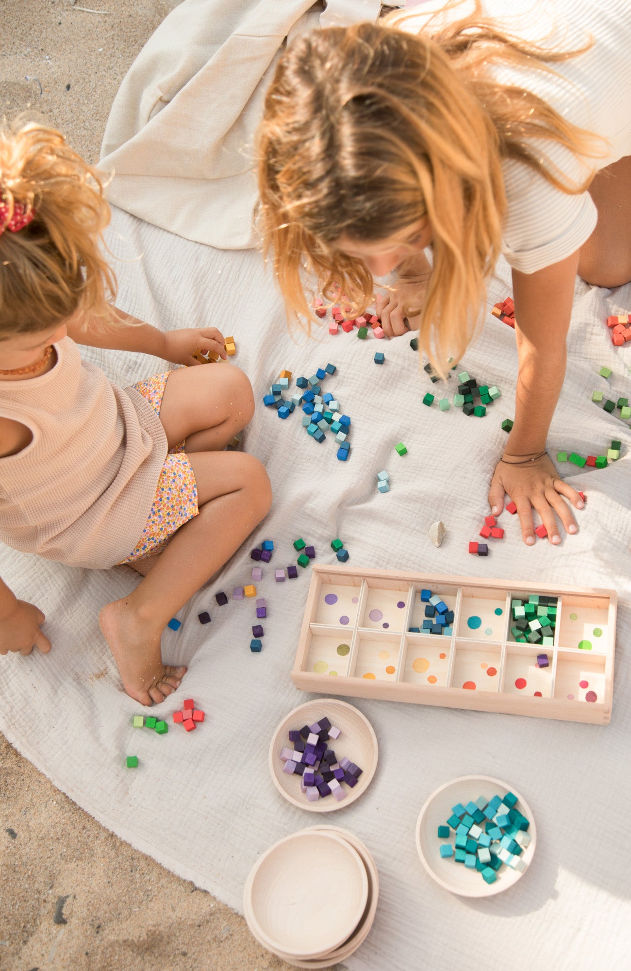 Two children playing with Grapat Mis match sorting box