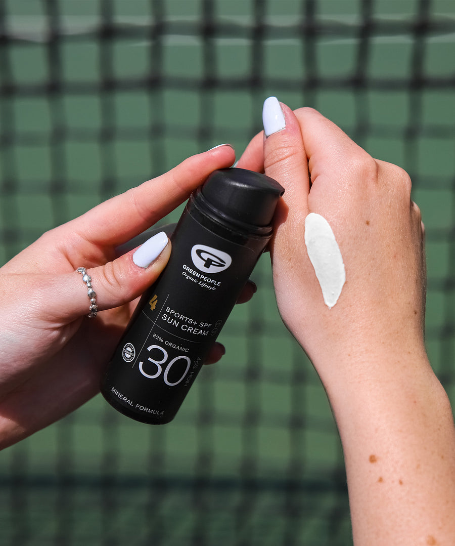 A person has spread some of the Green People Sports SPF30 Mineral Sun Cream 50ml onto their hand to show the colour of the cream