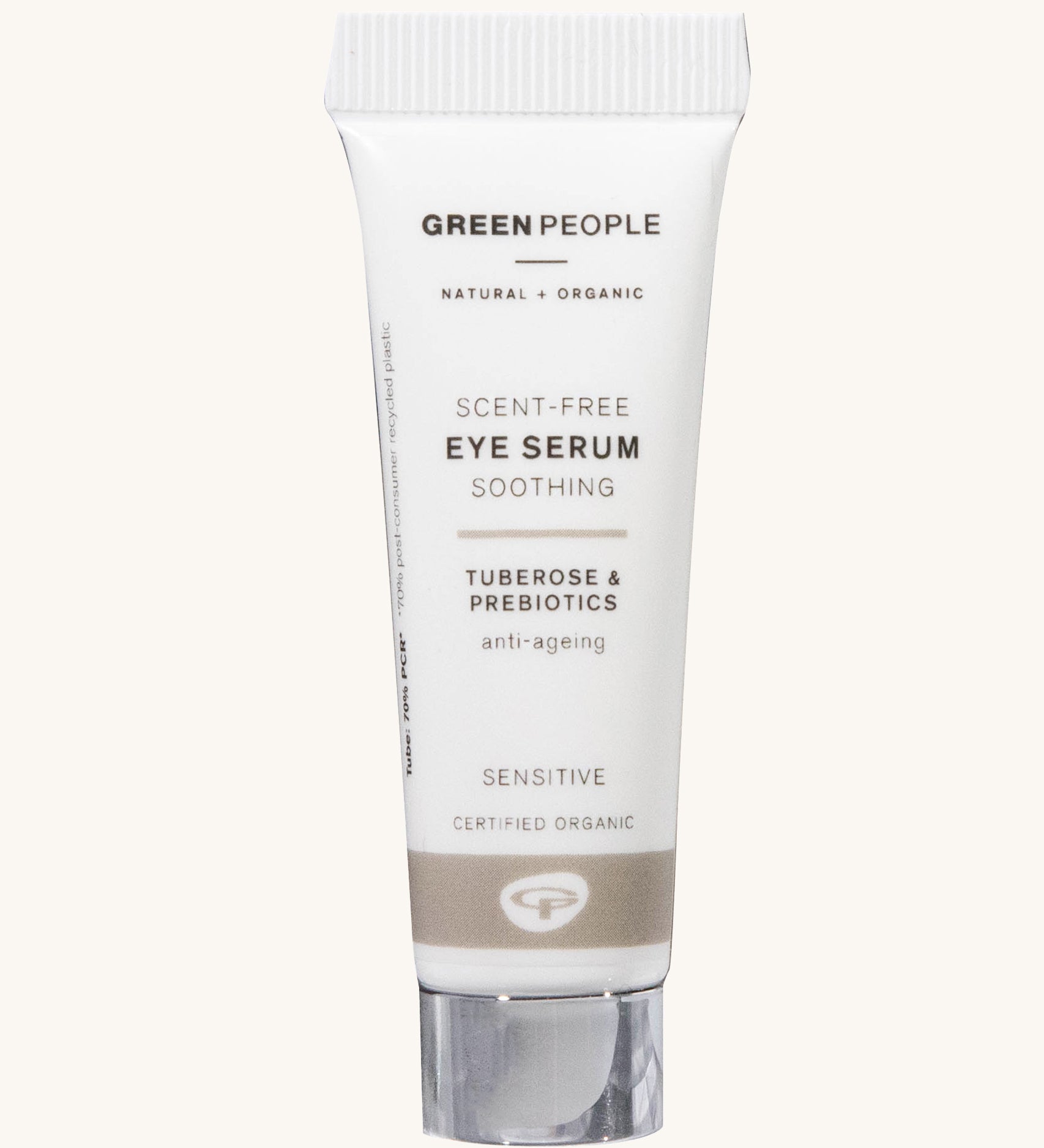 The Green People Scent Free Eye Serum is soothing for sensitive skin, organic, and anti-ageing. The cream is in a white tube with a silver lid and a light brown stripe. The image is on a cream background