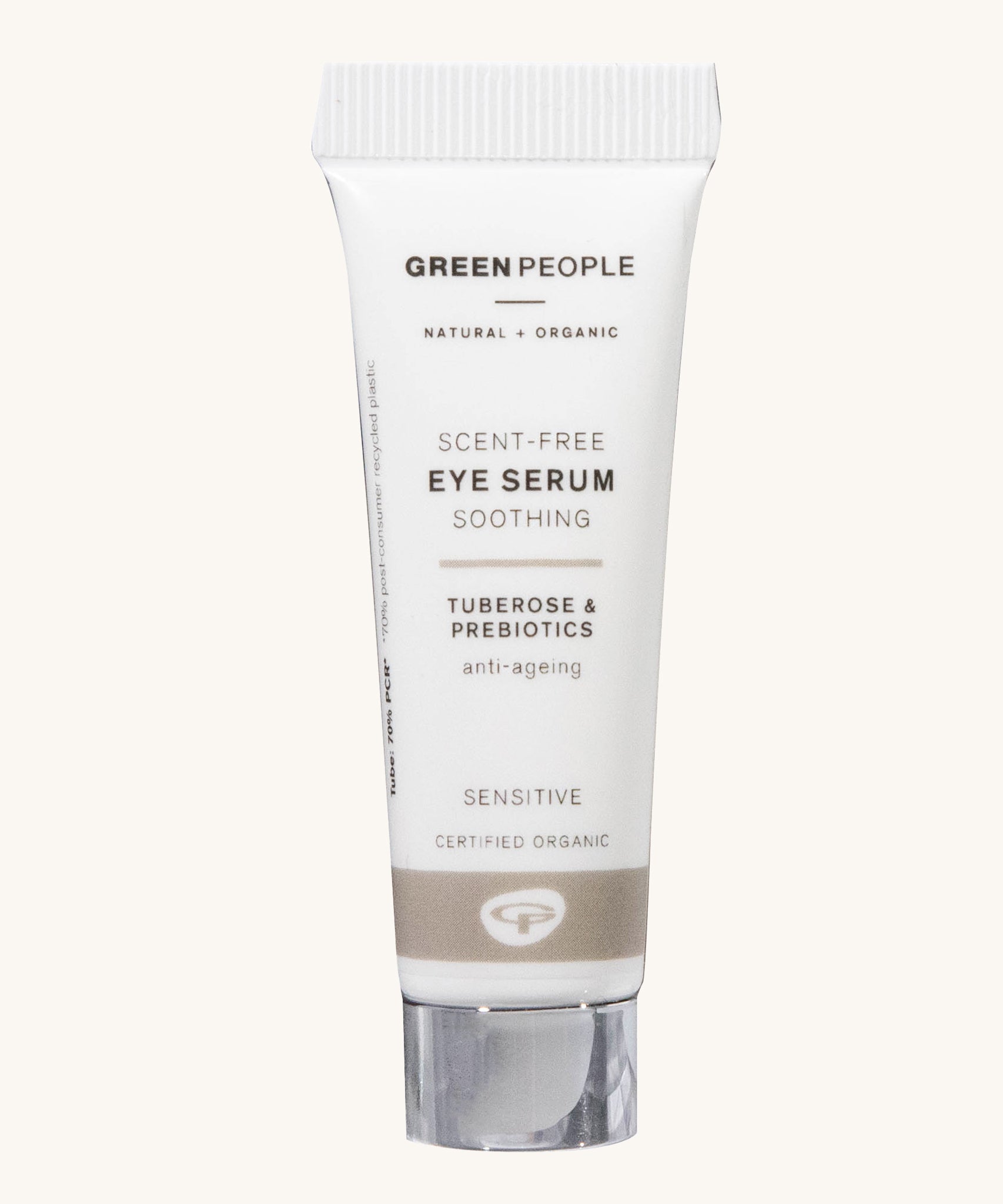 The Green People Scent Free Eye Serum is soothing for sensitive skin, organic, and anti-ageing. The cream is in a white tube with a silver lid and a light brown stripe. The image is on a cream background