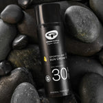 The Green People Sports SPF30 Mineral Facial Sun Cream 50ml laying on grey rocks