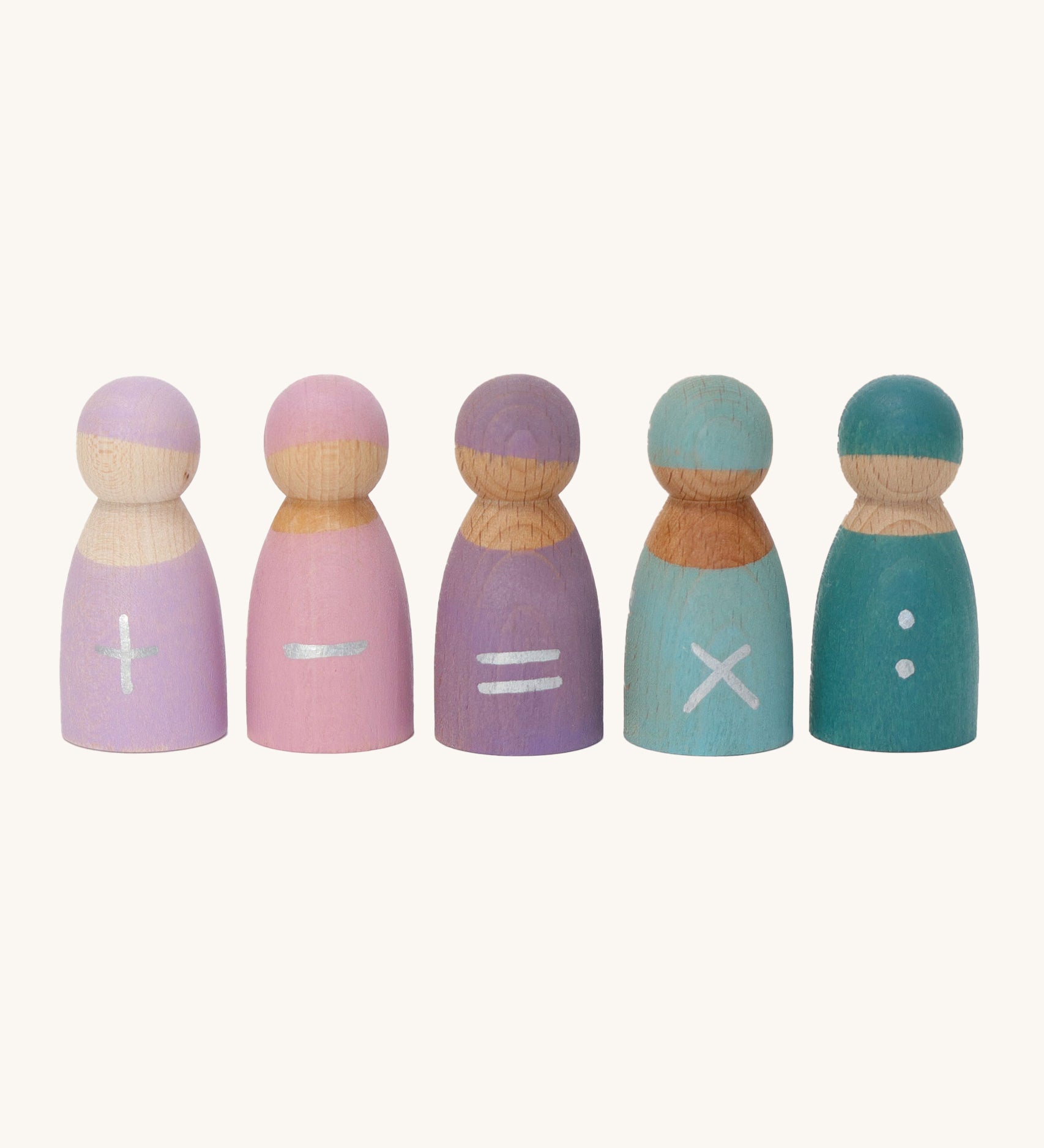 Grimm's 5 Maths Friends wooden pastel peg dolls each with a mathematical symbol painted on the front. From left to right is an addition sign, a subtraction sign, an equals sign, a multiplication sign and two dots as a divide sign, on a cream background.