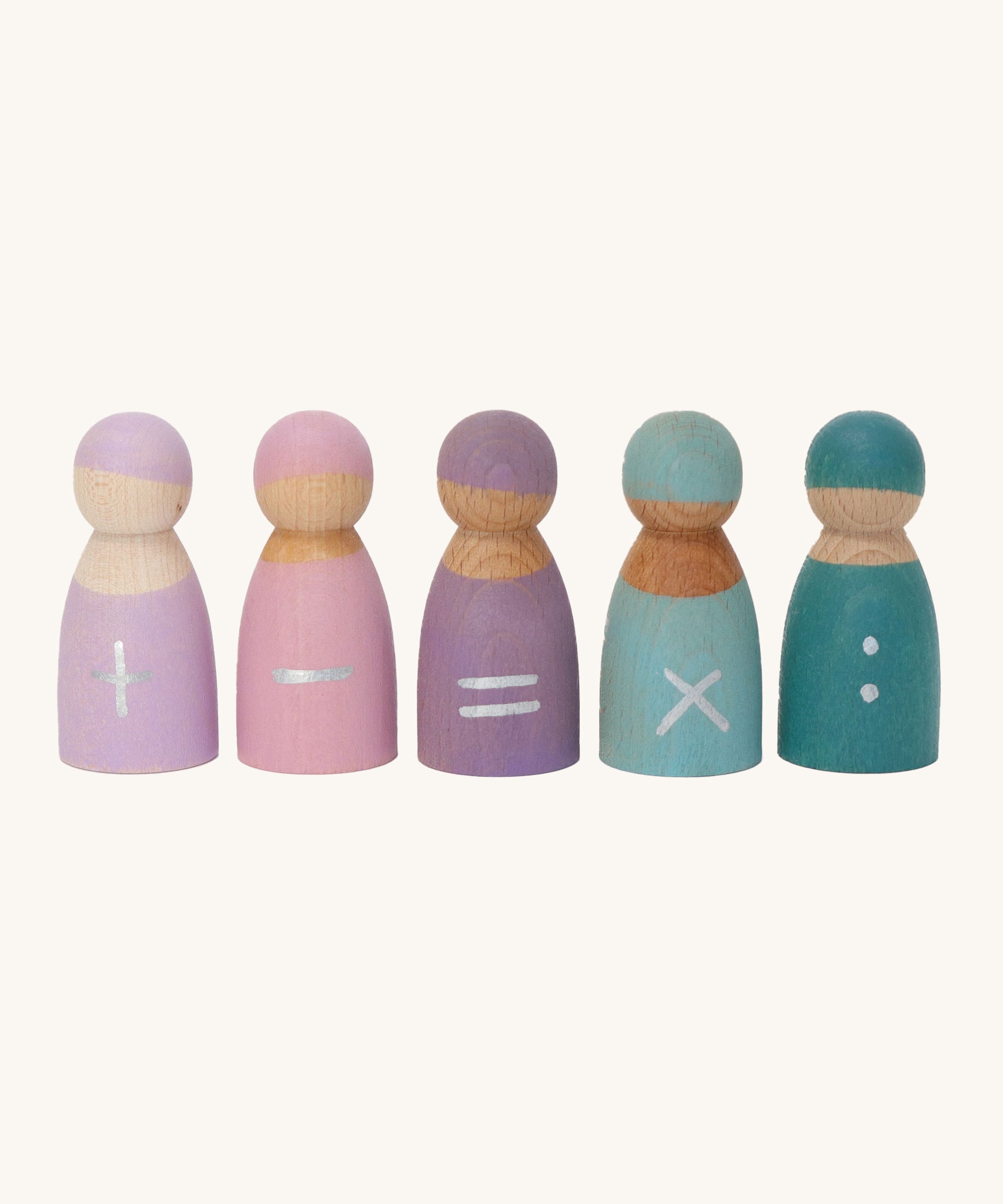 Grimm's 5 Maths Friends wooden pastel peg dolls each with a mathematical symbol painted on the front. From left to right is an addition sign, a subtraction sign, an equals sign, a multiplication sign and two dots as a divide sign, on a cream background.