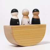 A angular view of the Grimm's 3 in a Boat Monochrome, showing the thickness of the natural wooden boat and the three peg dolls sat inside