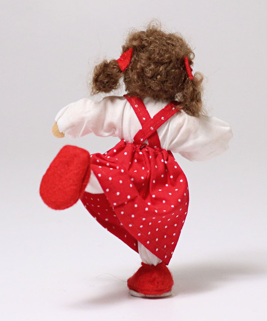 The back of Grimm's Brown Haired Girl Doll - Lana, stood on one leg with the other leg point out behind the doll, showing how flexible the doll is