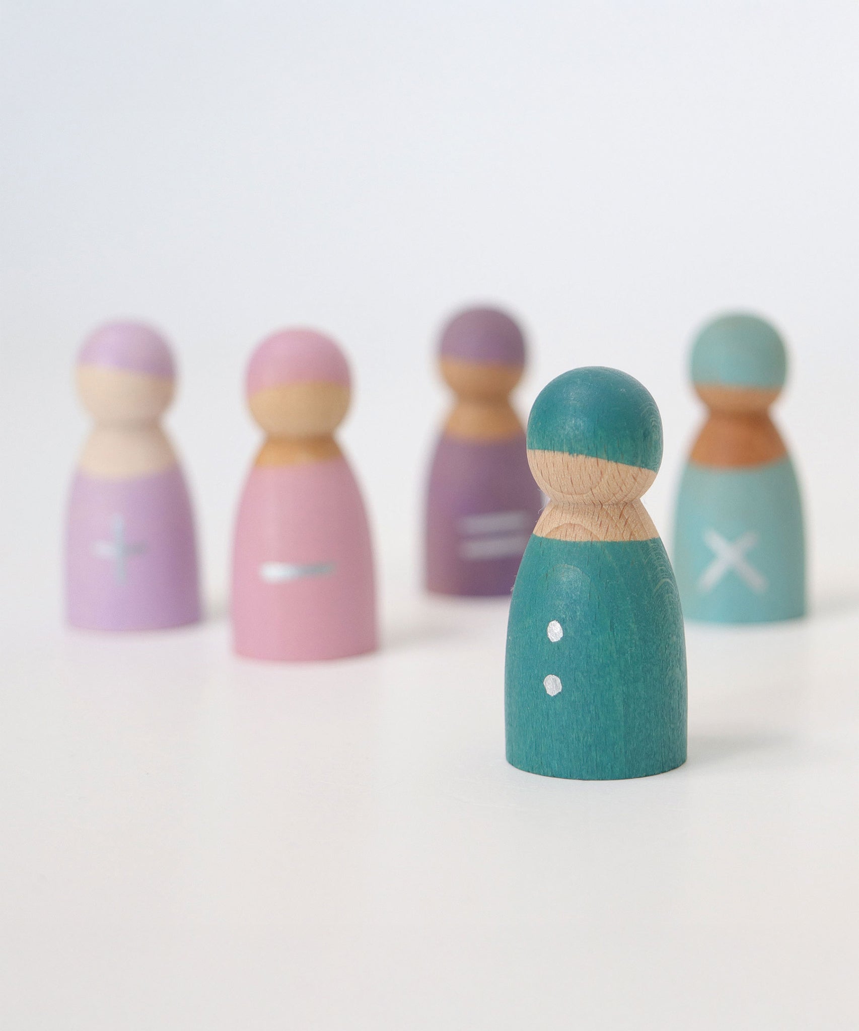 A closer look at the turquoise divide wooden peg doll from the Grimm's 5 Maths Friends, with two silver hand painted dots 