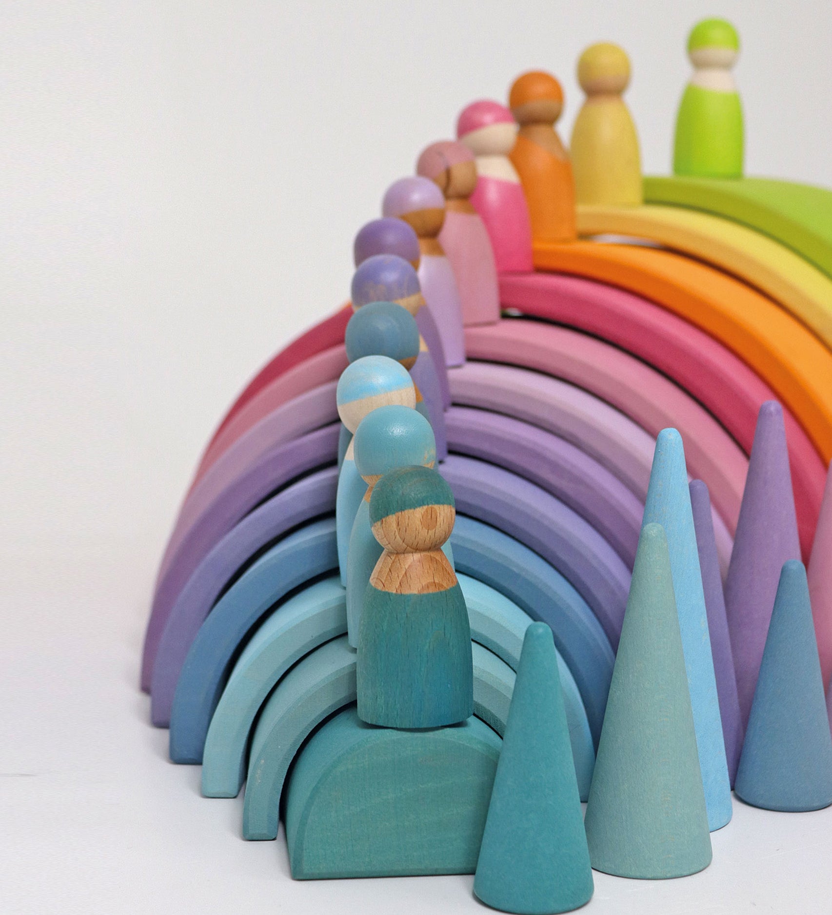 The The Grimm's 12 Pastel Friends stood on top of the Grimm's Pastel Rainbow arches with pastel Grimm's cones as the side.