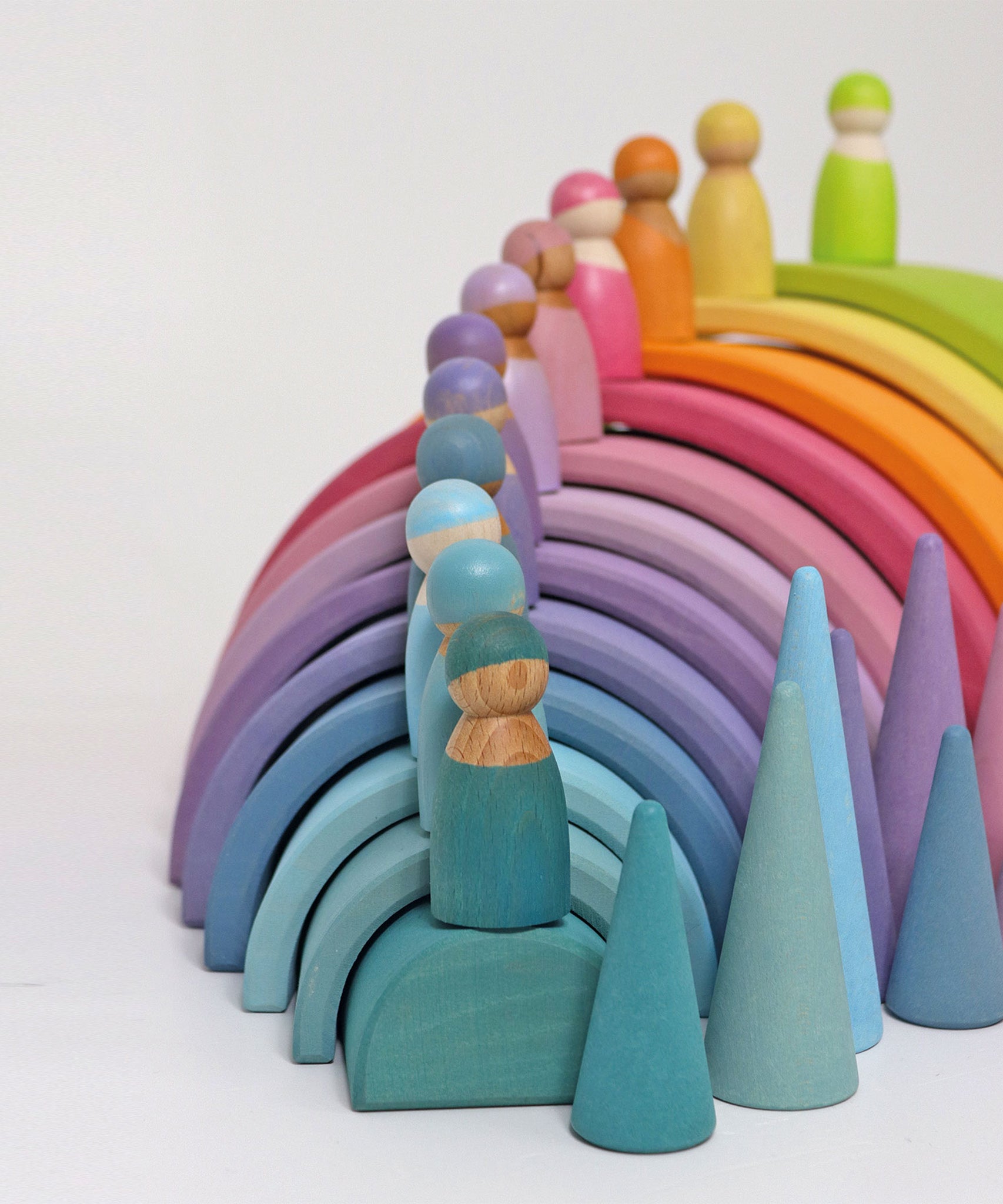 The The Grimm's 12 Pastel Friends stood on top of the Grimm's Pastel Rainbow arches with pastel Grimm's cones as the side.