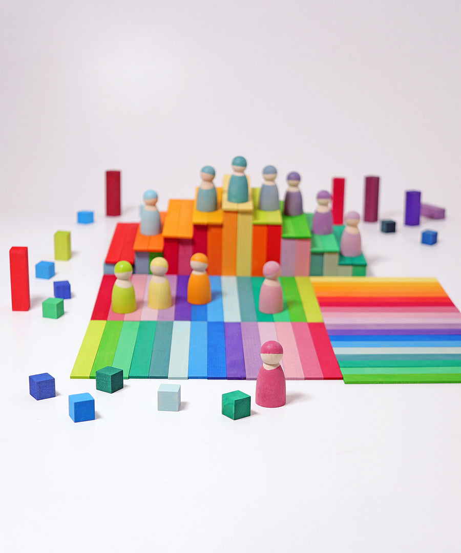 The Grimm's 12 Pastel Friends stood on top of colourful Grimm's wooden Leonardo Sticks