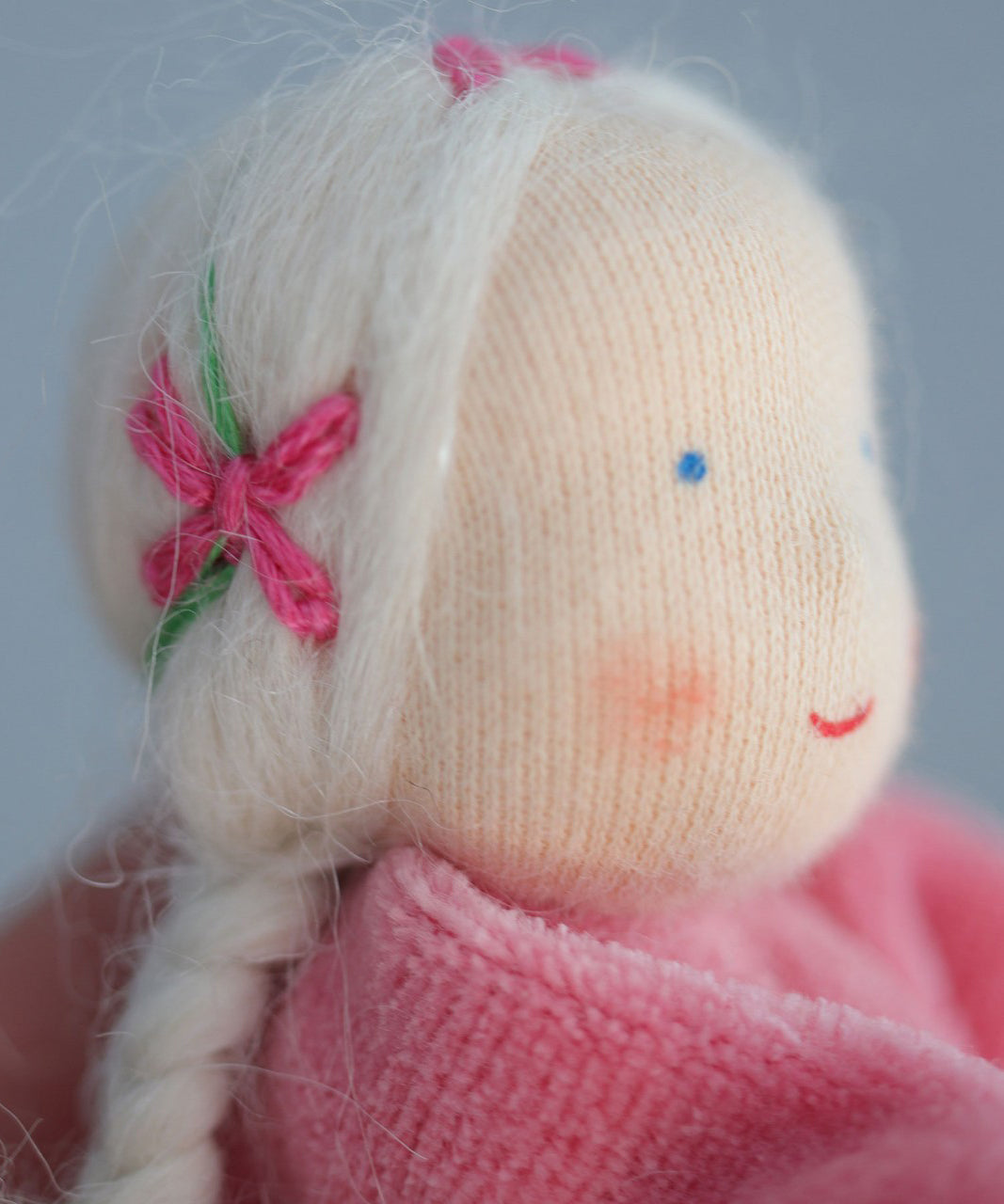 A closer look at the hair on the Grimm's Pink Lavender Girl showing pink embroidered bows with green vines