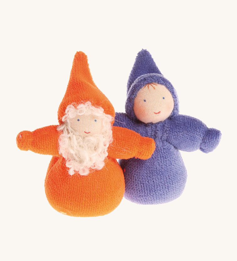 An Orange Bearded Grimm's Dwarf, and a rainbow Indigo Grimm's Dwarf next to each other on a cream background