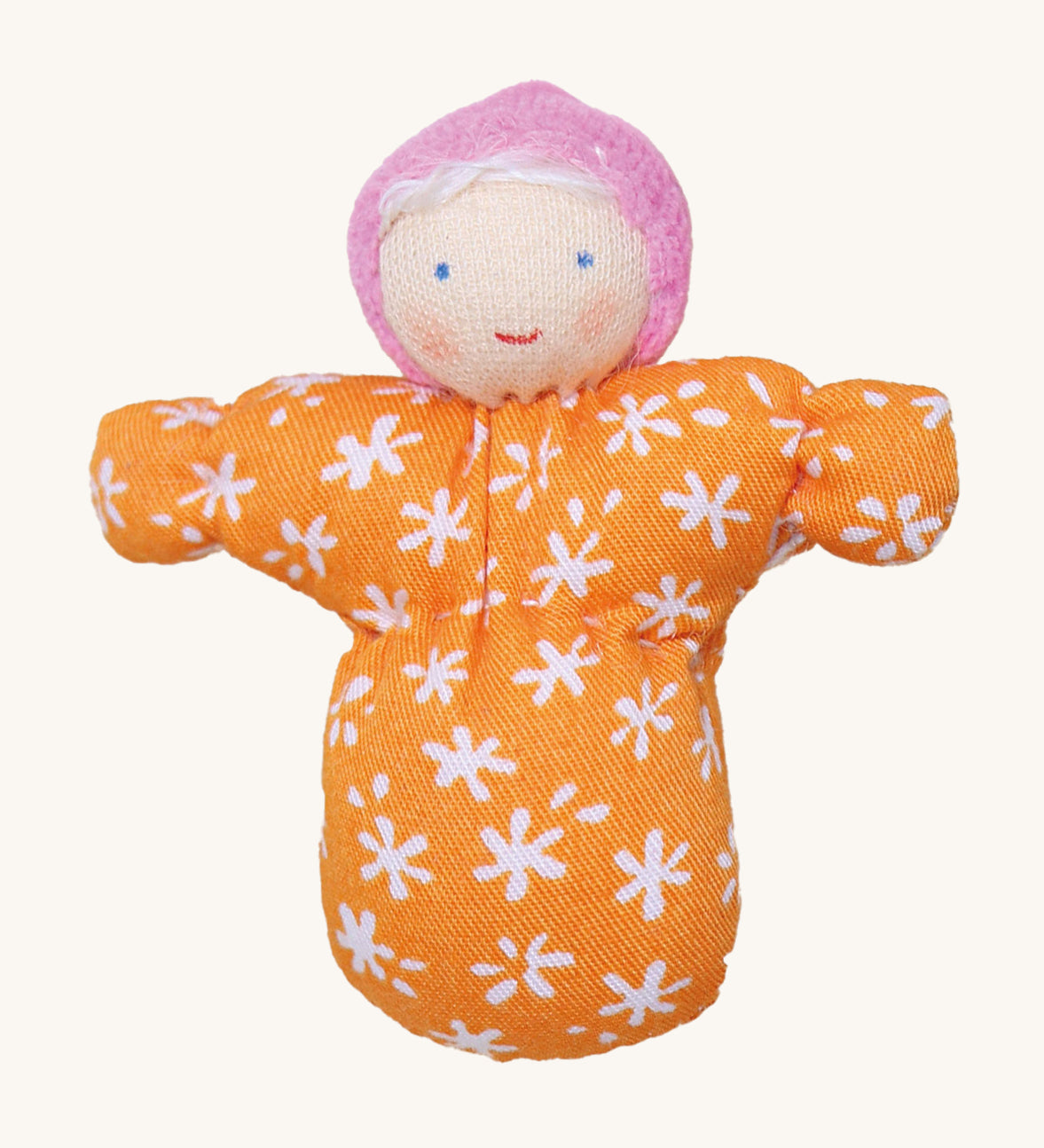 Grimm's Baby Mia Doll has a lovely warm smiling face. Mia also has a handmade fabric orange and white flower body, a light pink hat and white hair. The image is on a cream background