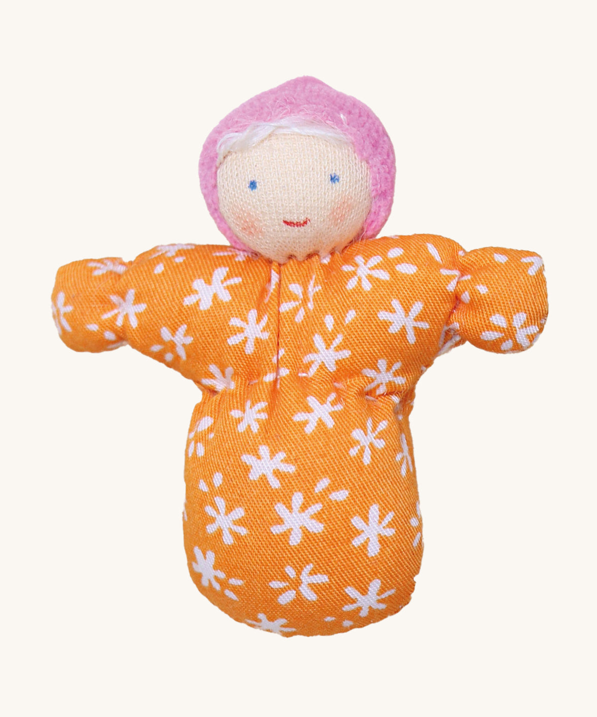 Grimm's Baby Mia Doll has a lovely warm smiling face. Mia also has a handmade fabric orange and white flower body, a light pink hat and white hair. The image is on a cream background