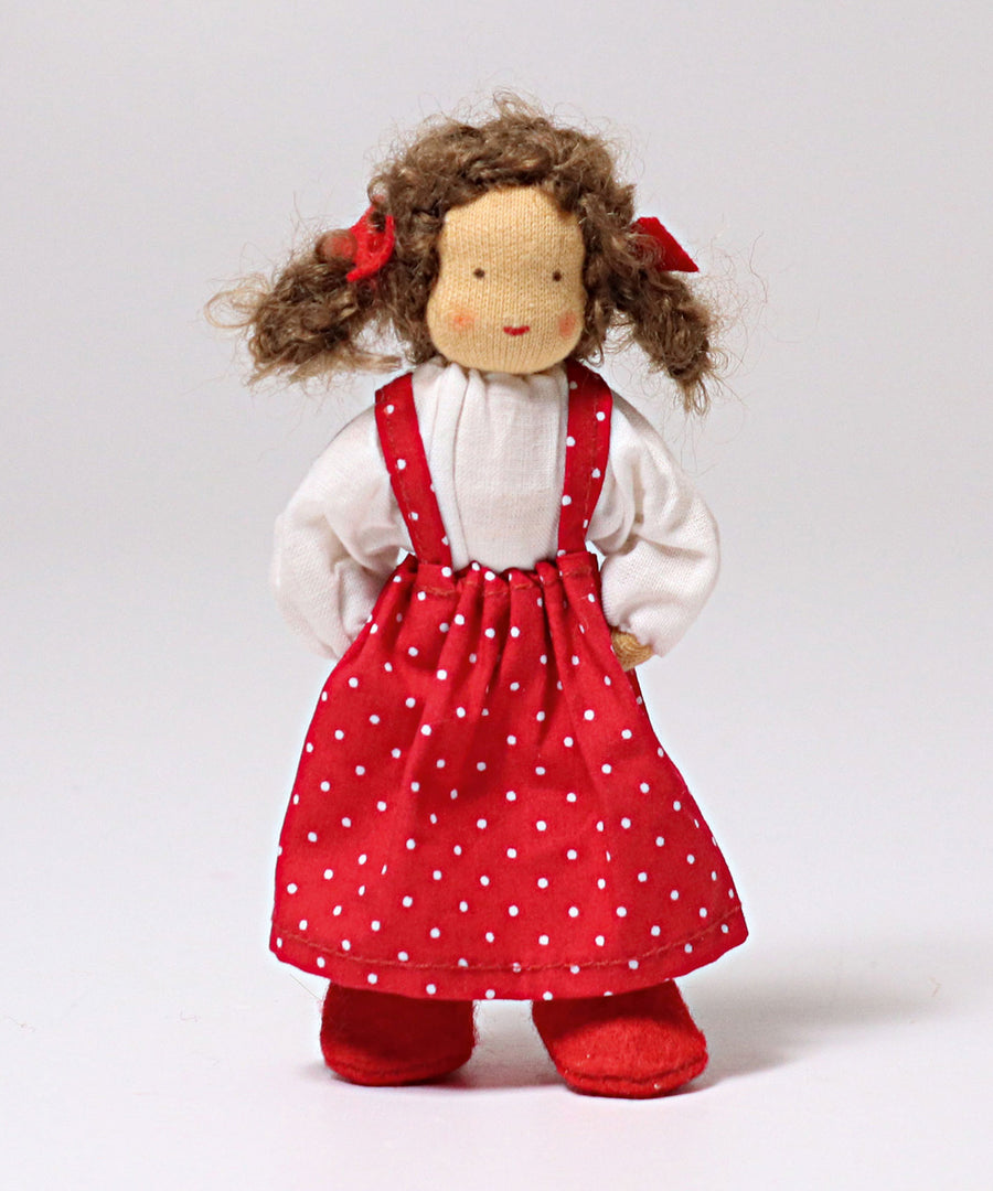 Lana is stood with its hand behind its back, showing the flexibility in the arms of the fabric doll