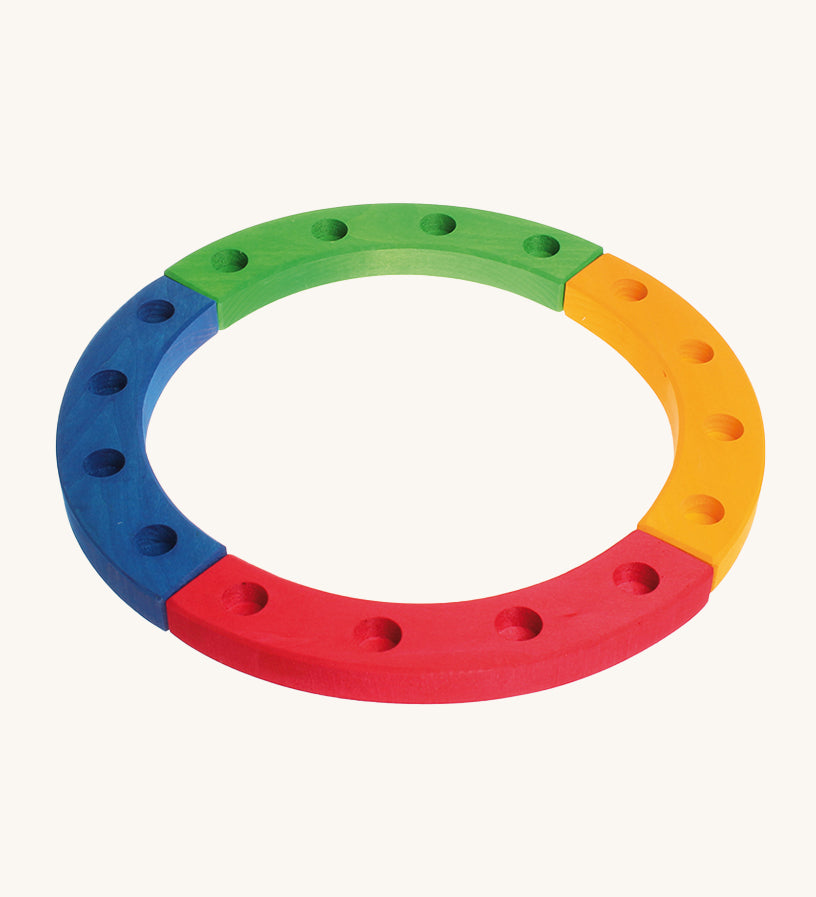 Grimm's 16-Hole Coloured Wooden Celebration Ring on a cream background