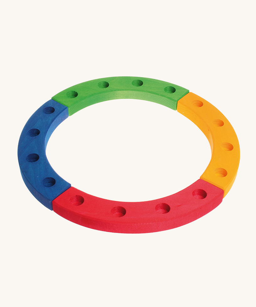 Grimm's 16-Hole Coloured Wooden Celebration Ring on a cream background