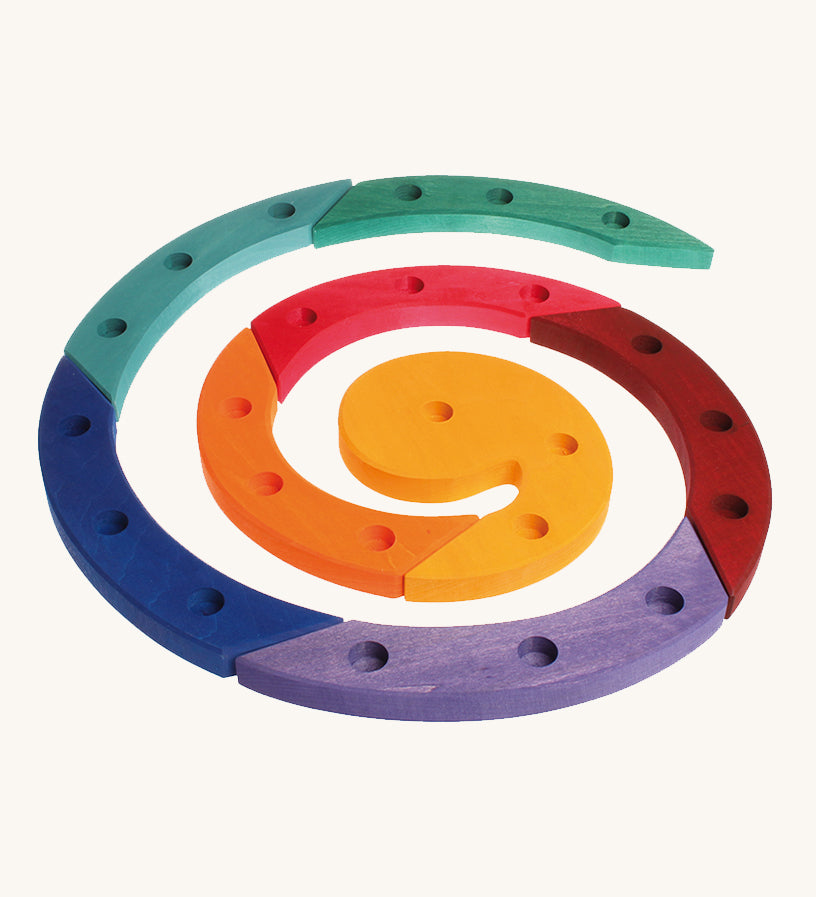 Grimm's Coloured Wooden Spiral come in 8 colourful wooden sections, each with 3 hole to put Grimm's decorative figures and candles inside. The image is on a cream background