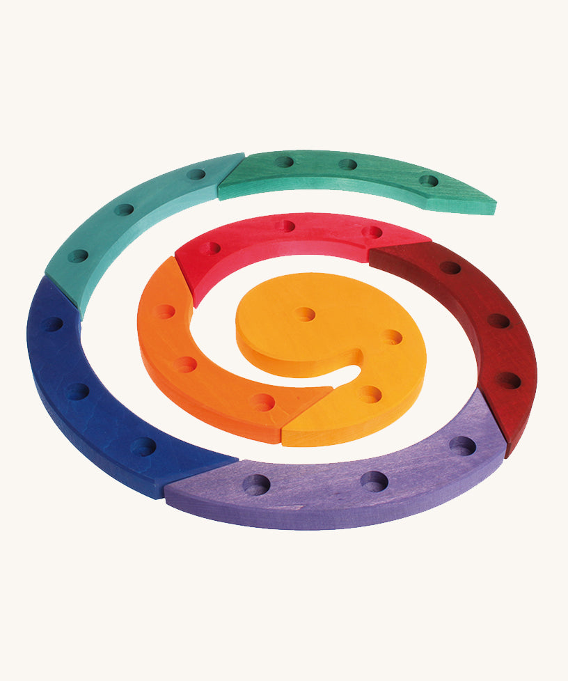 Grimm's Coloured Wooden Spiral come in 8 colourful wooden sections, each with 3 hole to put Grimm's decorative figures and candles inside. The image is on a cream background